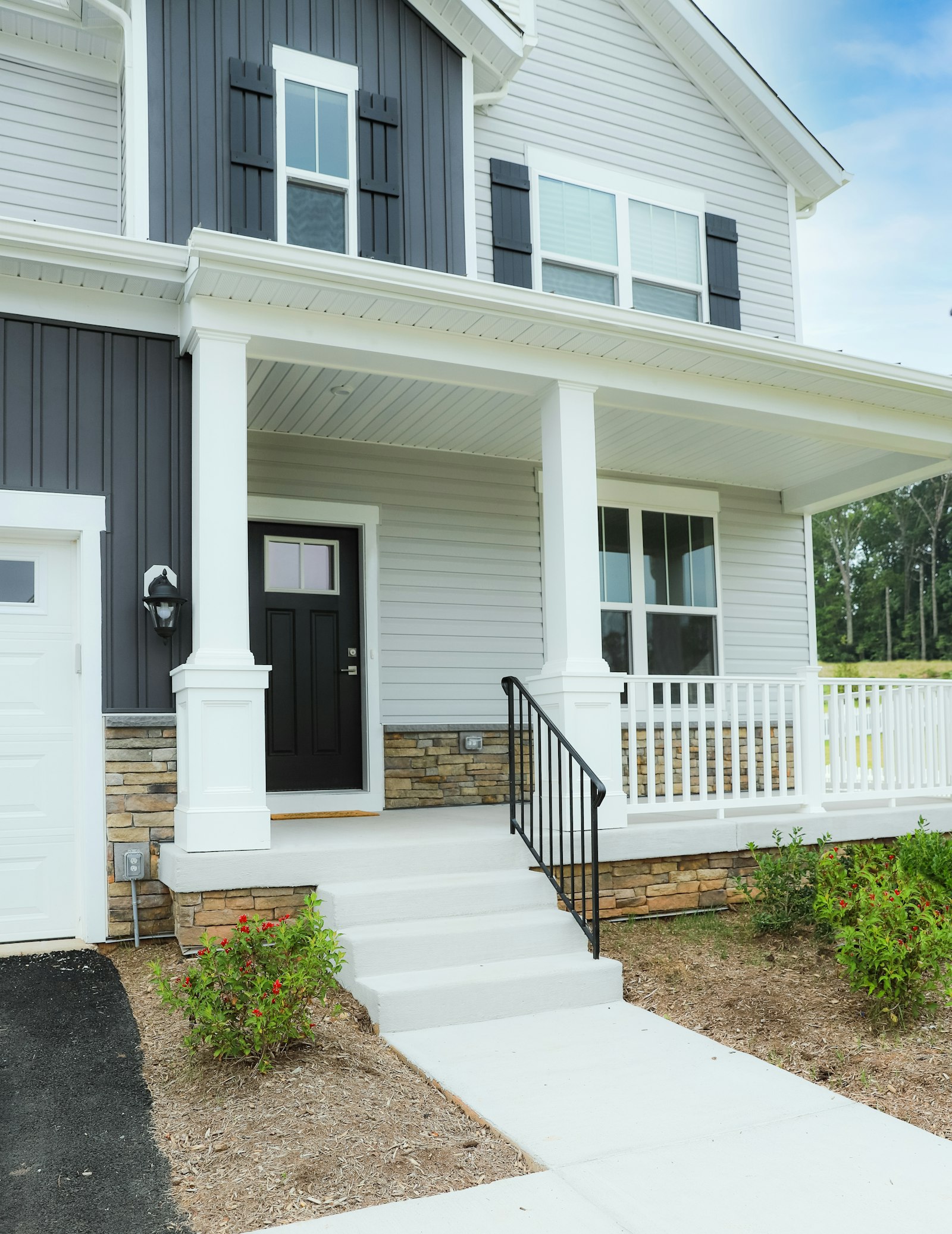 Front entry with a craftsman door and white-trimmed windows.